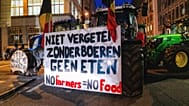 A farmer drives a tractor bearing a sign reading 'Without farmers, there is no food' during a protest outside the EU Summit in Brussels, Dec. 18, 2025