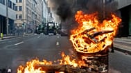 A fire burns in a barrel as European farmers block a road with their tractors during a demonstration outside the EU Summit in Brussels, 18 December 2025
