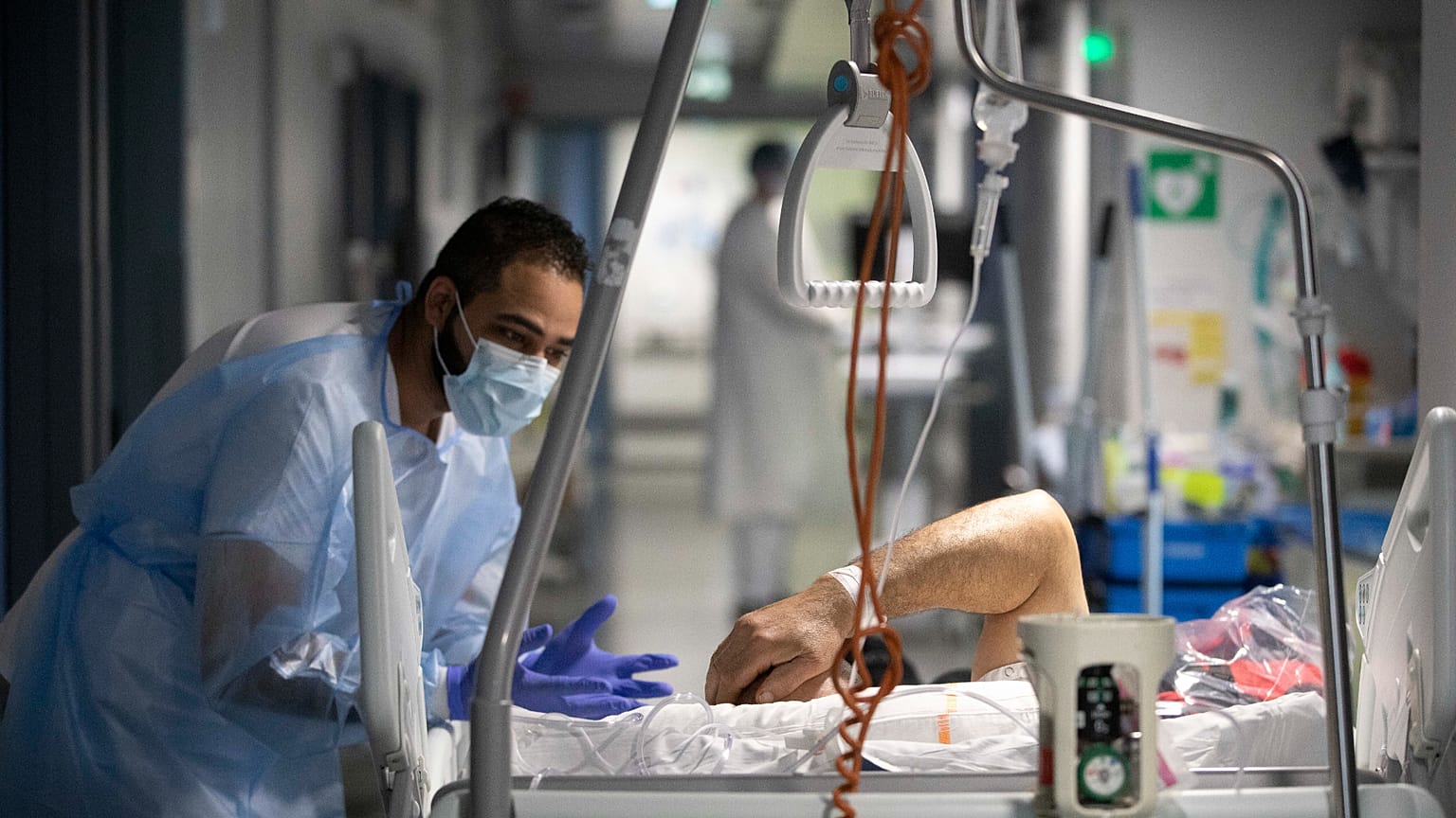 أحد أفراد الطاقم الطبي يتحدث مع مريض بمستشفى جامعة ستراسبورغ شرق فرنسا، الخميس 13 يناير/كانون الثاني 2022