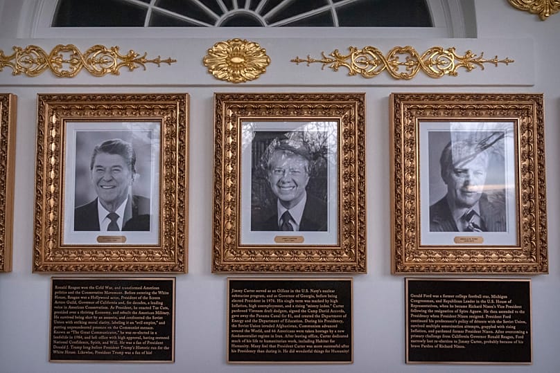 Portraits of former Presidents Reagan, Carter and Ford with plaques in the White House colonnade, Wednesday, 17 December 2025.
