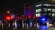 People gather outside a storage facility where a suspect in the shooting at Brown University was found dead, Thursday, Dec. 18, 2025, in Salem, N.H.