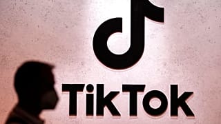 FILE - A visitor passes the TikTok exhibition stands at the Gamescom computer gaming fair in Cologne, Germany. 25 August 2022