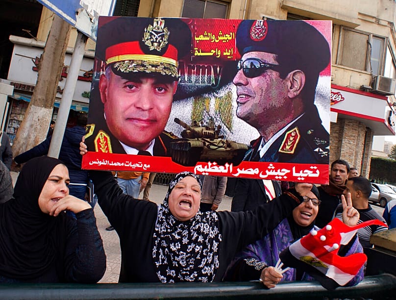 FILE: Supporters of Egypt's President Abdel Fattah el-Sissi shout slogans of support to the army as they hold a poster with his picture, in Cairo, 25 January 2017