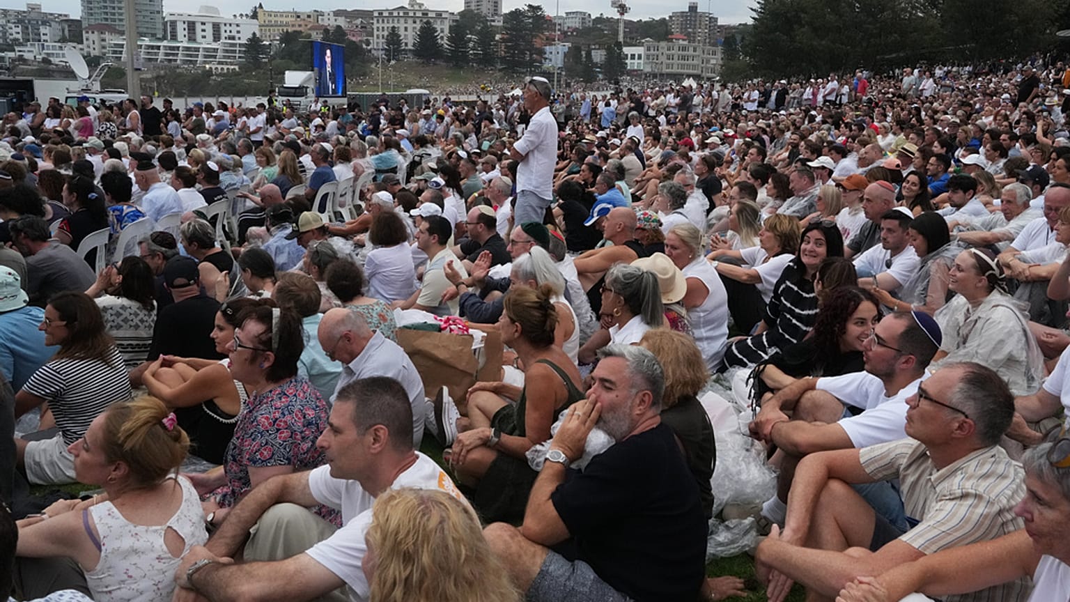 Attendees listen to David Ossip, president of the New South Wales Jewish Board of Deputies, during a ceremony to mark the  at Bondi Beach in Sydney, Sunday, 21 December 2025. 