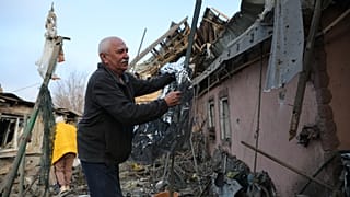 A man clears the rubble of his house destroyed after a Russian attack on Zaporizhzhia, Ukraine, Friday,19 December 2025. 