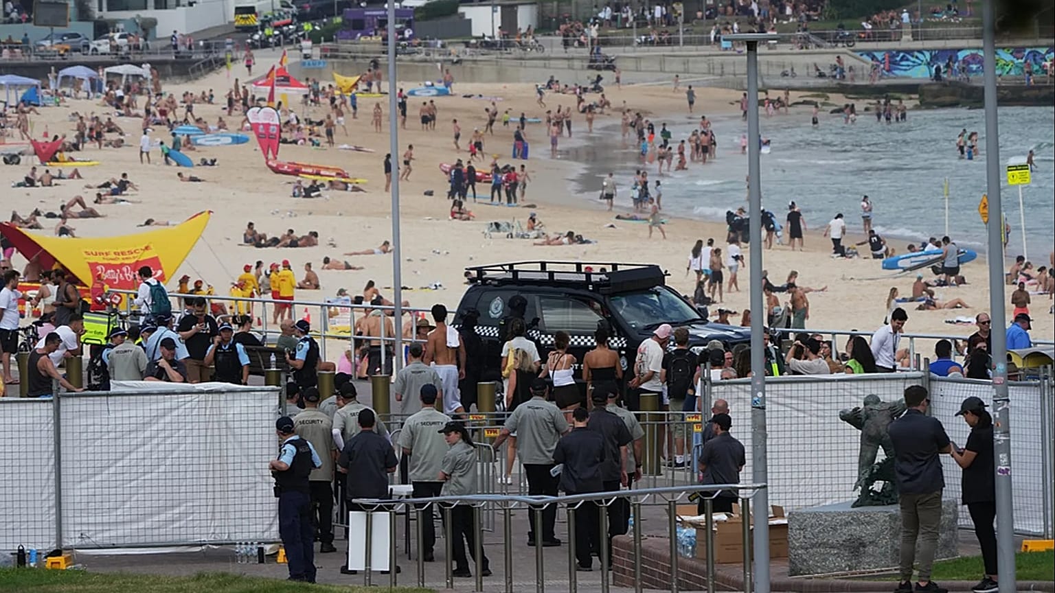 Security gathers at a gate at Bondi Beach in Sydney ahead of a ceremony to mark National Day of Reflection for victims and survivors from the Bondi shooting, Dec. 21, 2025.