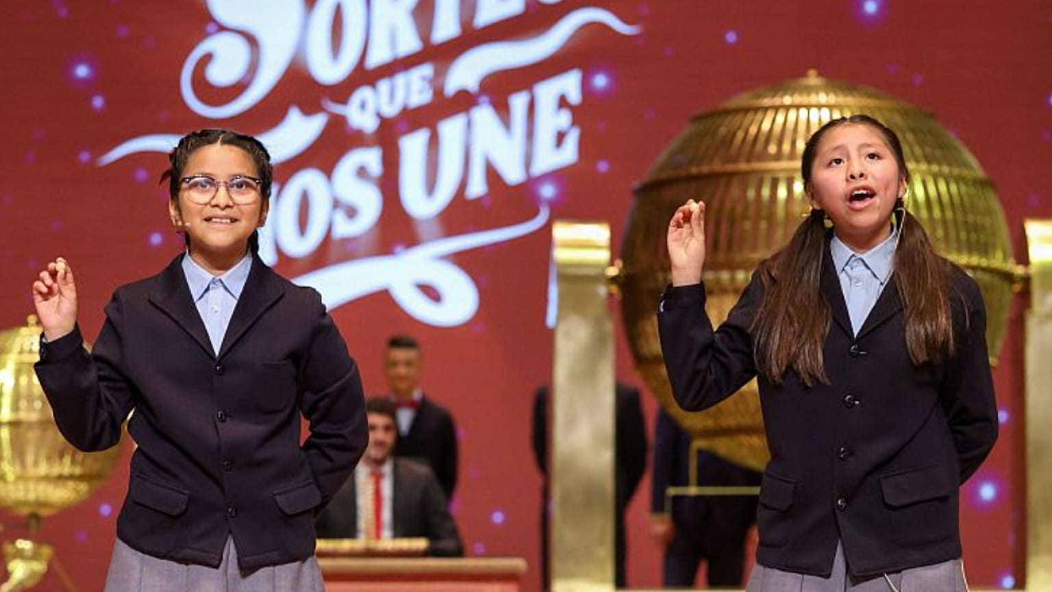 Las niñas de San Ildefonso Alba Yadira Machaca e Italy Andrea Blanco tras cantar el premio Gordo de la Lotería de Navidad en 2025.