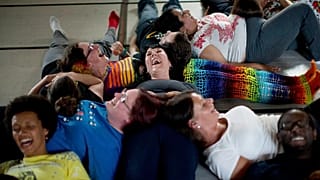 People laugh as they take part in performing a group exercise during a laughter yoga class in St. Albans, England on 9 June 2013