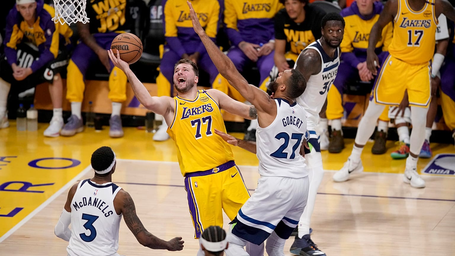 FILE: Los Angeles Lakers guard Luka Doncic goes to the basket against Minnesota Timberwolves centre Rudy Gobert and forward Jaden McDaniels, in Los Angeles, 22 April 2025