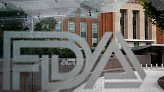 FILE - The U.S. Food and Drug Administration building is seen behind FDA logos at a bus stop on the agency's campus in Silver Spring, Md., Aug. 2, 2018.