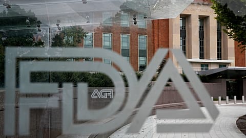 FILE - The U.S. Food and Drug Administration building is seen behind FDA logos at a bus stop on the agency's campus in Silver Spring, Md., Aug. 2, 2018.