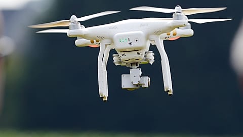 FILE - A DJI Phantom 3 drone flies during a drone demonstration at a farm and winery in the US state of Maryland in 2015.