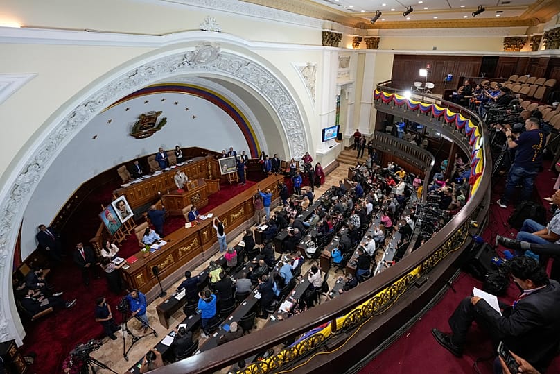 Lawmaker Giuseppe Alessandrello gives a speech during an extraordinary session at the National Assembly in Caracas, Venezuela, Monday, Dec. 22, 2025.