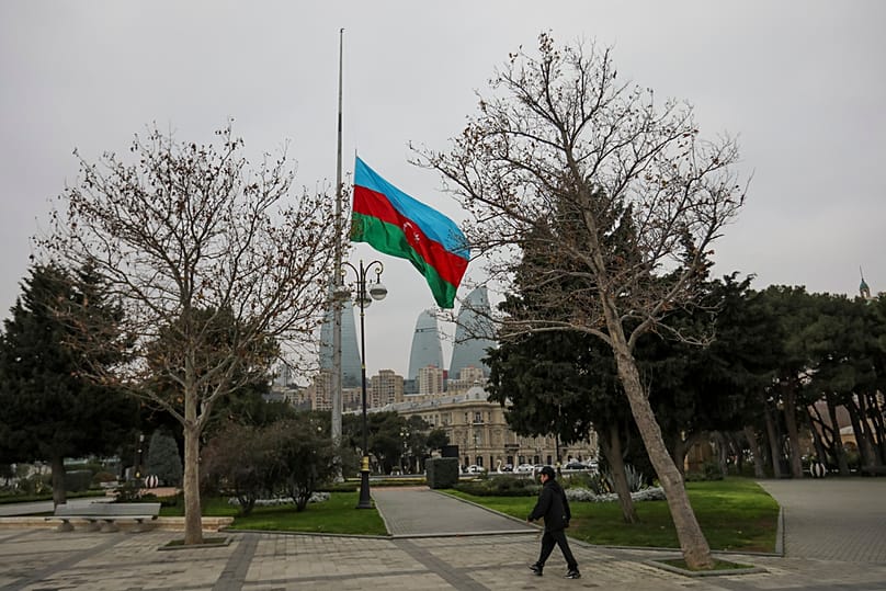 FILE: Azerbaijan national flag at half-mast in memory of the victims of Azerbaijan Airlines flight that crashed near the Kazakhstan airport of Aktau, in Baku, 26 December 2025