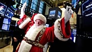 FILE - FILE - In this Wednesday, Nov. 25, 2015, file photo, Santa Claus visits the trading floor of the New York Stock Exchange before the opening bell.