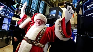 FILE - FILE - In this Wednesday, Nov. 25, 2015, file photo, Santa Claus visits the trading floor of the New York Stock Exchange before the opening bell.