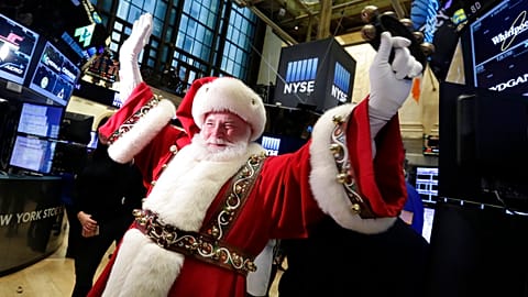 FILE - FILE - In this Wednesday, Nov. 25, 2015, file photo, Santa Claus visits the trading floor of the New York Stock Exchange before the opening bell.