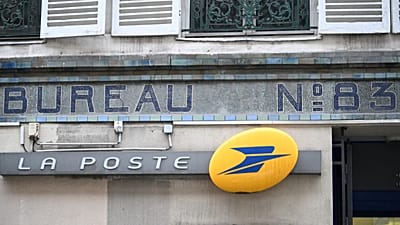 The logo of France's national postal service La Poste is pictured outside a post office, in Paris, 23 December 2025