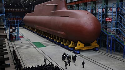 Kim Jong-un inspects a nuclear-powered submarine under construction at an undisclosed location in North Korea, undated