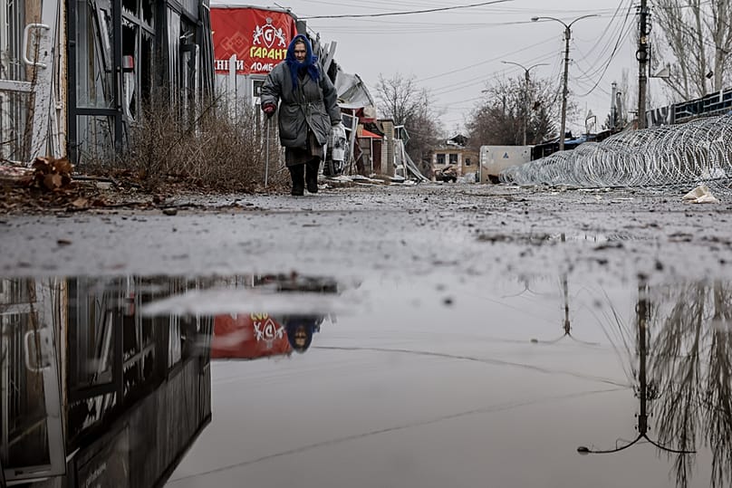 FILE: A resident goes along a street in the frontline town of Kostyantynivka, in the Donetsk region, Ukraine, 20 December 2025