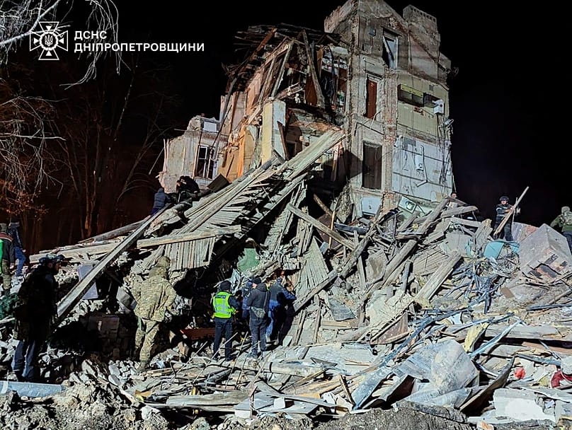 FILE: Firefighters work on a site of an apartment building destroyed by a Russian attack in Kryvyi Rih, 25 December 2025