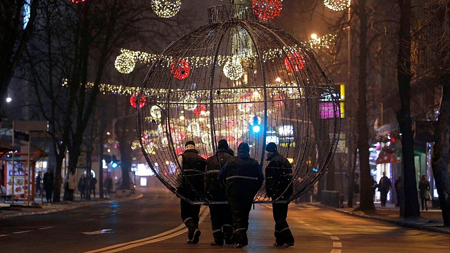 FILE: Workers carry a giant Christmas decoration through a street decorated for Christmas and New Year holidays, in downtown Skopje, 21 December 2015