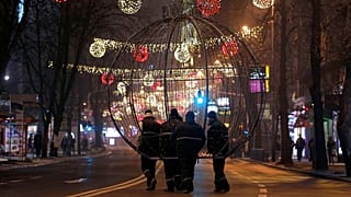 FILE: Workers carry a giant Christmas decoration through a street decorated for Christmas and New Year holidays, in downtown Skopje, 21 December 2015