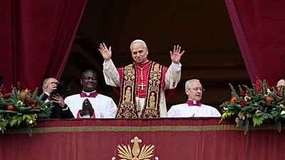 Pope Leo XIV waves after delivering the Urbi et Orbi Christmas Day blessing from the main balcony of St. Peter's Basilica at the Vatican, 25 December 2025