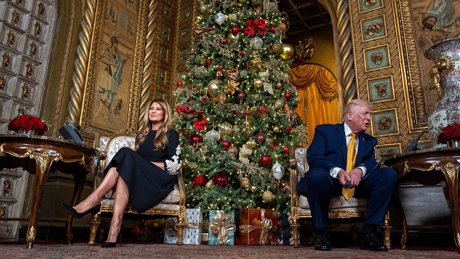 US President Donald Trump accompanied by first lady Melania Trump during a NORAD Tracks Santa Operation call at his Mar-a-Lago, 24 December 2025