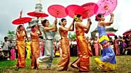 Dai women perform a umbrella dance in Manyangguang village