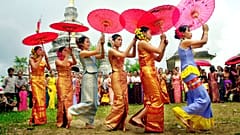 Dai women perform a umbrella dance in Manyangguang village
