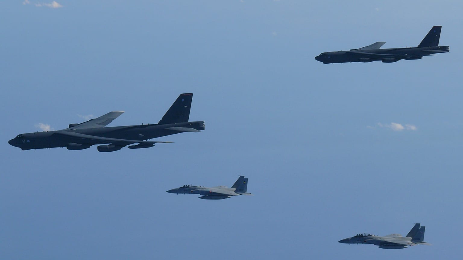 This photo provided by Japan's Ministry of Defense shows the Japan Air Self-Defense Force's F-15 fighters holding a joint military drill with the U.S. B-52 bombers in the vici