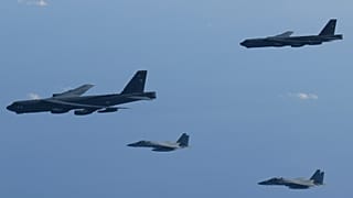 This photo provided by Japan's Ministry of Defense shows the Japan Air Self-Defense Force's F-15 fighters holding a joint military drill with the U.S. B-52 bombers in the vici