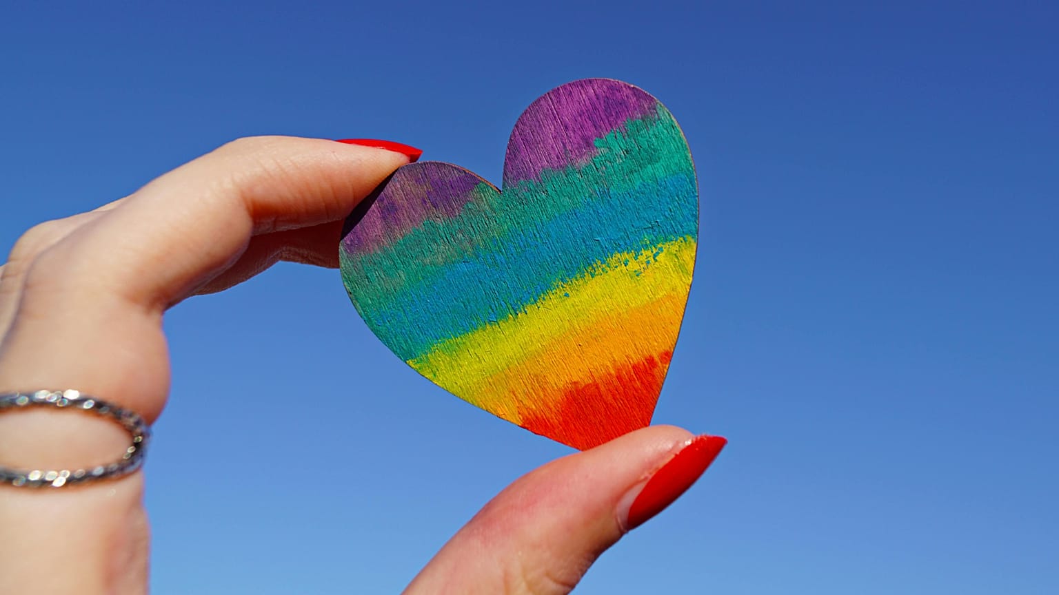 Person holding multicolored heart decor