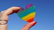 Person holding multicolored heart decor