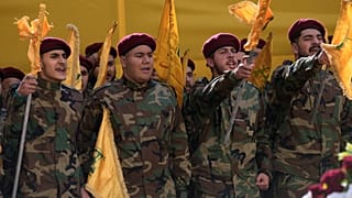 FILE: Hezbollah fighters shout slogans during the funeral procession of Hezbollah's chief of staff, Haytham Tabtabai, in the southern suburb of Beirut, 24 November 2025