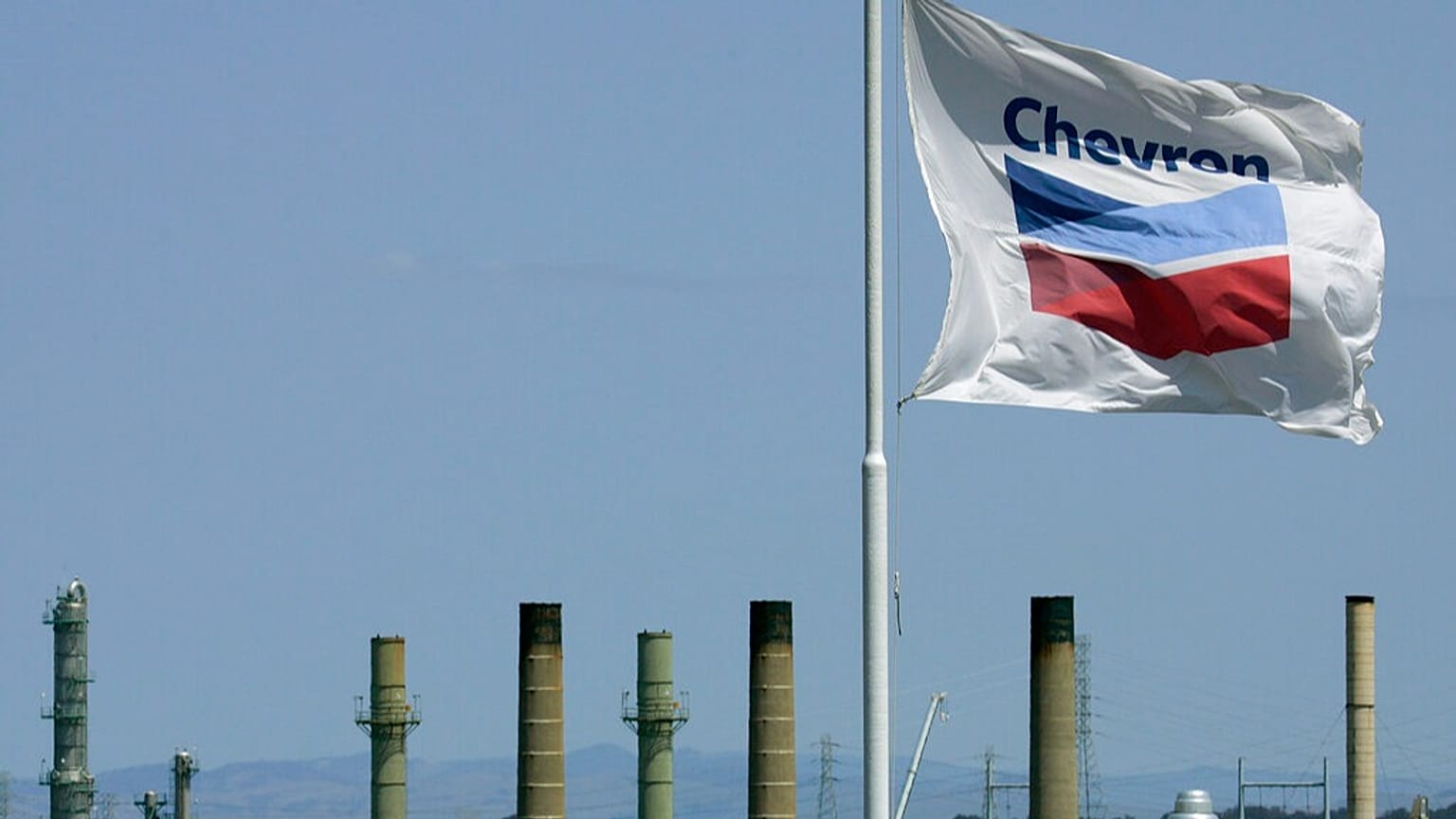 FILE - This April 21, 2008 file photo shows a Chevron flag flying over the Chevron refinery in Richmond, California.