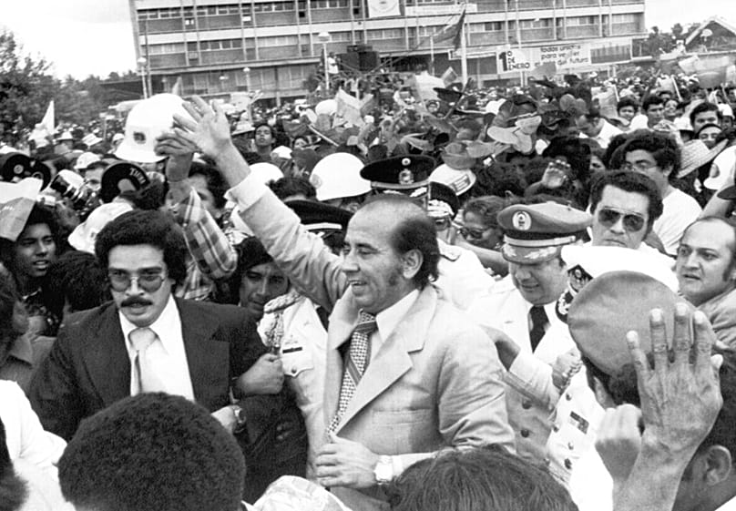 FILE - President Carlos Andres Perez is surrounded by well-wishers following New Year's Day ceremonies in which the state took possession of Venezuela's national oil industry.
