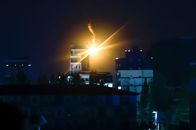 Illumination flares fired by Thai military forces shine in Poipet, Cambodia, as seen from Sa Kaeo, Thailand, on Friday, Dec. 26, 2025.