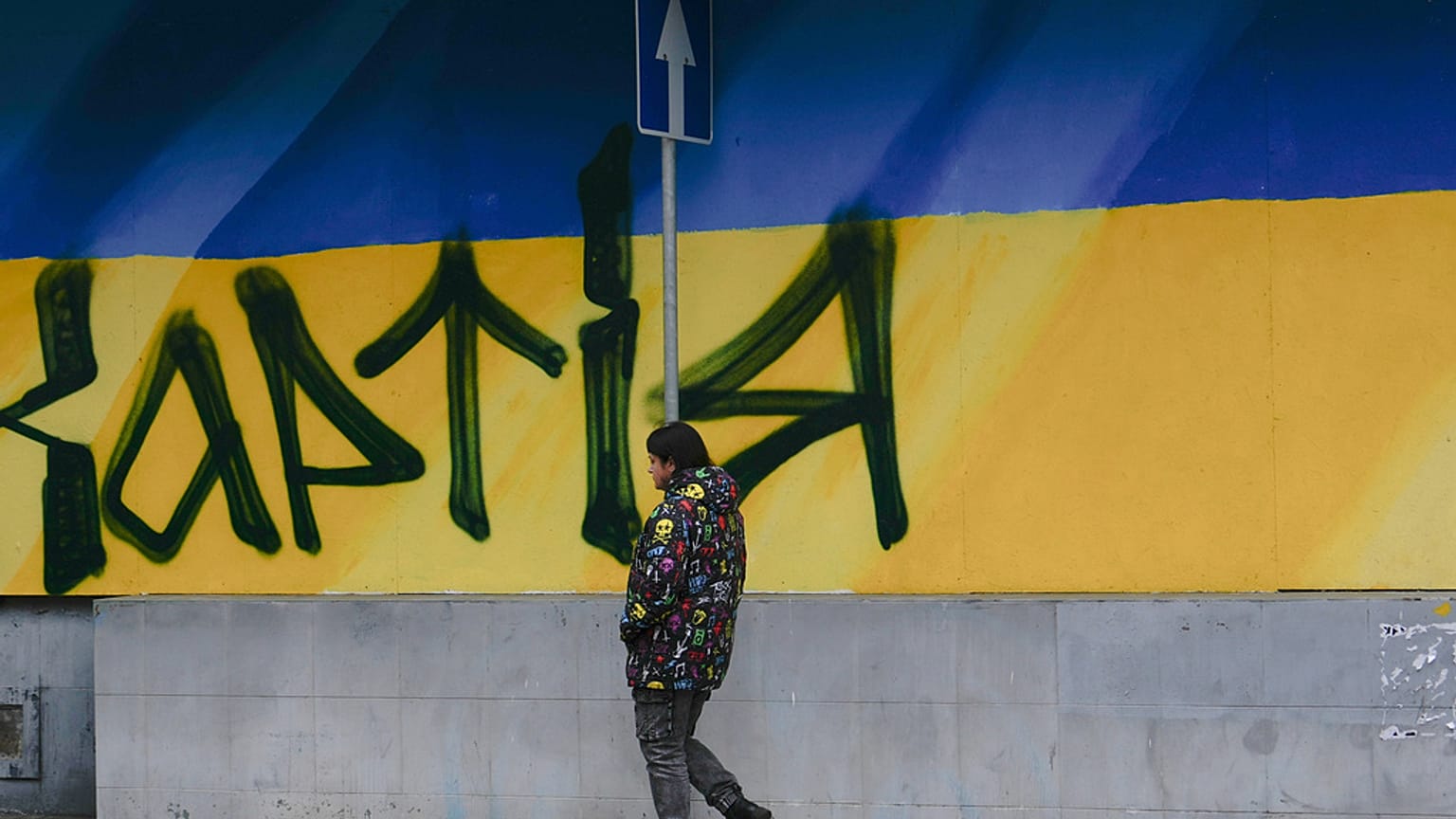 امرأة تمر بجوار جدارية علم أوكرانيا، يوم الجمعة 7 نوفمبر/تشرين الثاني 2025، في خاركيف، أوكرانيا.