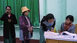 Voters register at a polling station in Naypyitaw, Myanmar, Sunday, Dec. 28, 2025. (AP Photo/Aung Shine Oo)