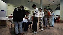 Voters line up to cast their ballots at a polling station Sunday, Dec. 28, 2025, in Yangon, Myanmar