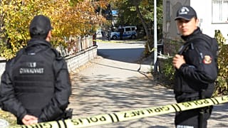 FILE: Security officials stand at the entrance of a house in the Turkish capital Ankara, 11 November 2022