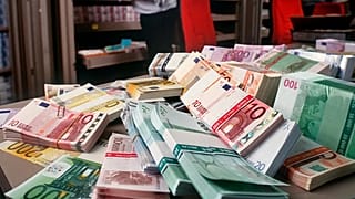 Eurobankjegyek egy asztalon a zürichi UBS bank devizahiteles részlegén 2001. december 13-án