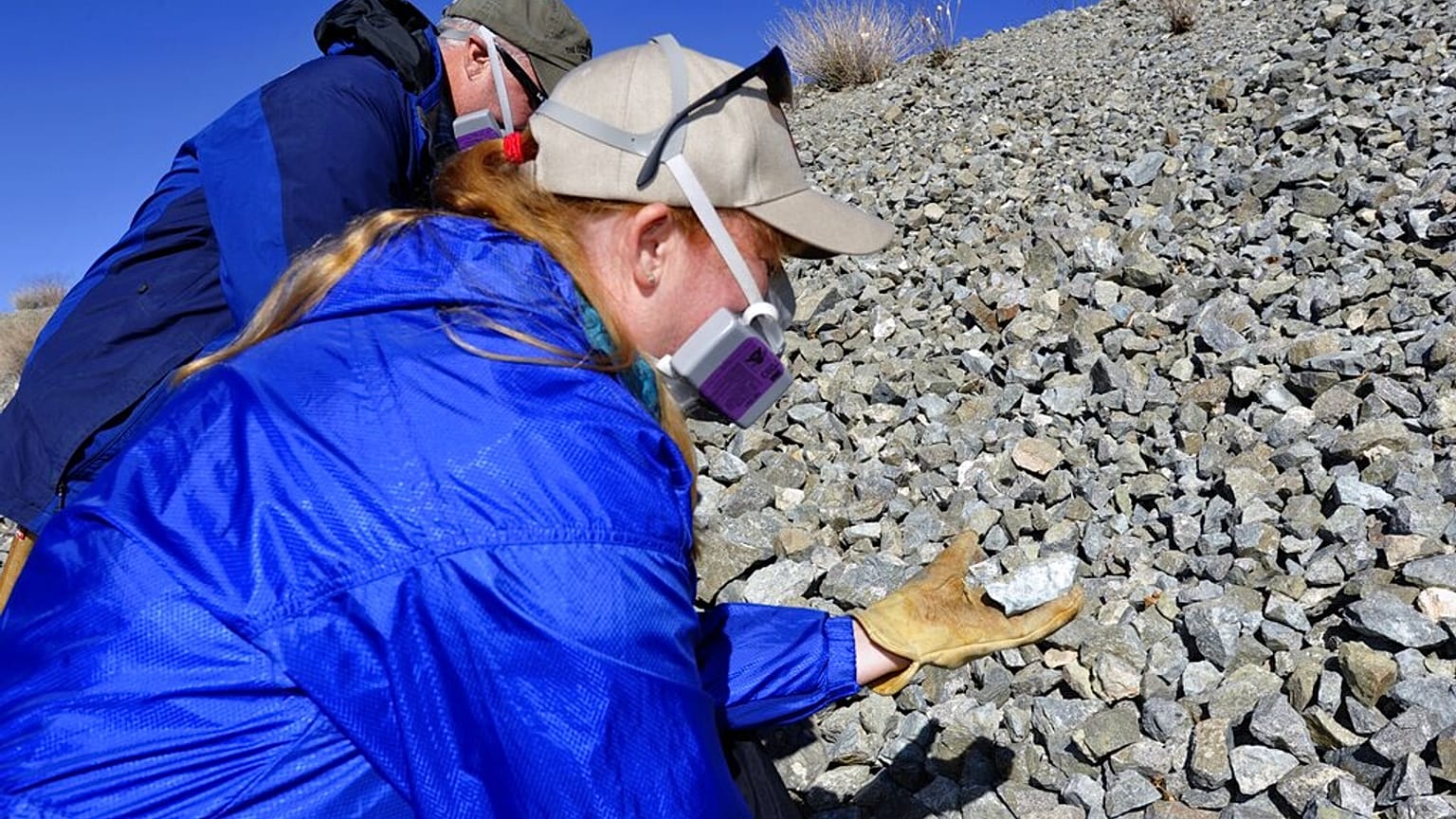 صورة تعبيرية-   يقوم أستاذا العلوم في جامعة نيفادا، لاس فيغاس، رودني ميتكالف (في الخلف) وبريندا باك، بفحص الصخور بحثًا عن الأسبستوس الطبيعي في جنوب شرق مدينة بولدر، نيفادا