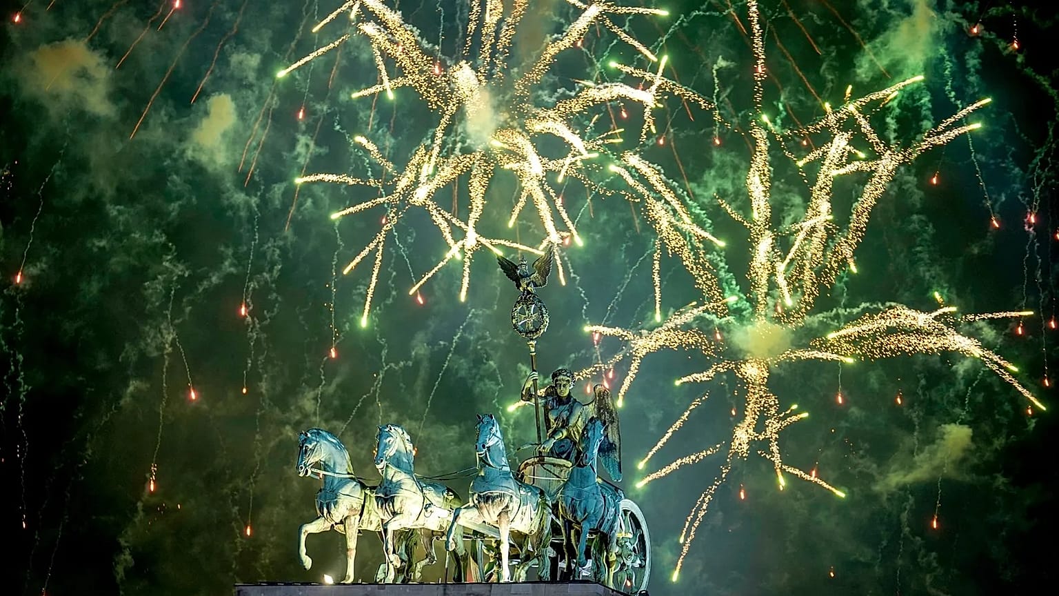 Fireworks light the sky above the Quadriga at the Brandenburg Gate during New Year's celebrations shortly after midnight in Berlin, 1 January, 2025
