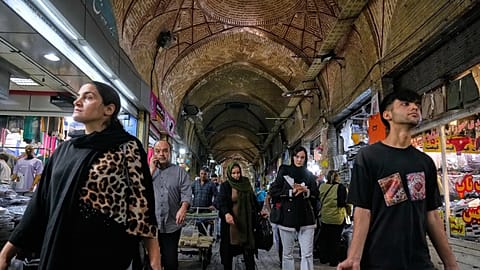 FILE - Your download is complete.  Live chat: Chat with an Expert  People walk through the old main bazaar of Tehran, Iran, 24 September 2025. (AP Photo/Vahid Salemi)