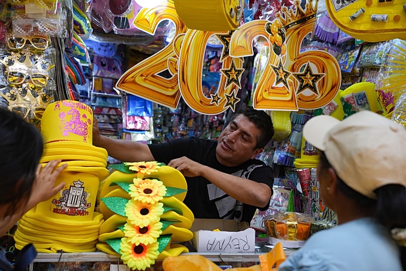 A vendor sells New Year's eve party goods at a market in downtown Lima, 30 December, 2025