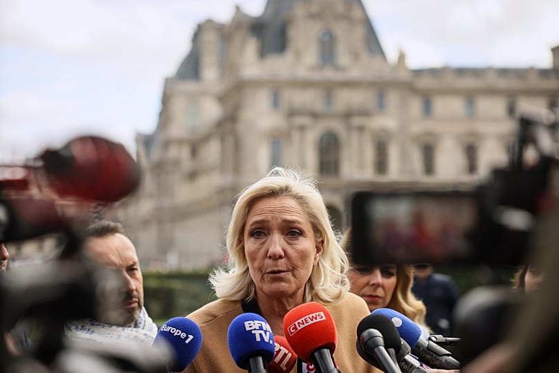 French far right leader Marine Le Pen answers reporters after visiting an exhibit beneath the Louvre museum Friday, Oct. 24, 2025