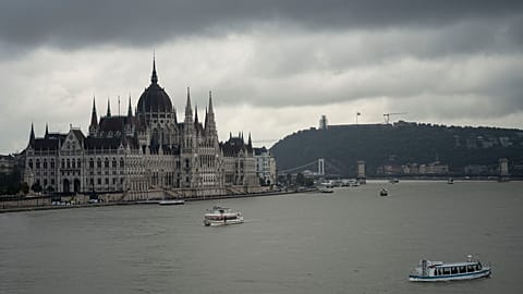 FILE - Dark clouds are seen over the Parliament building in Budapest, Hungary, during the flooding of the Danube river. 16 September 2024. 